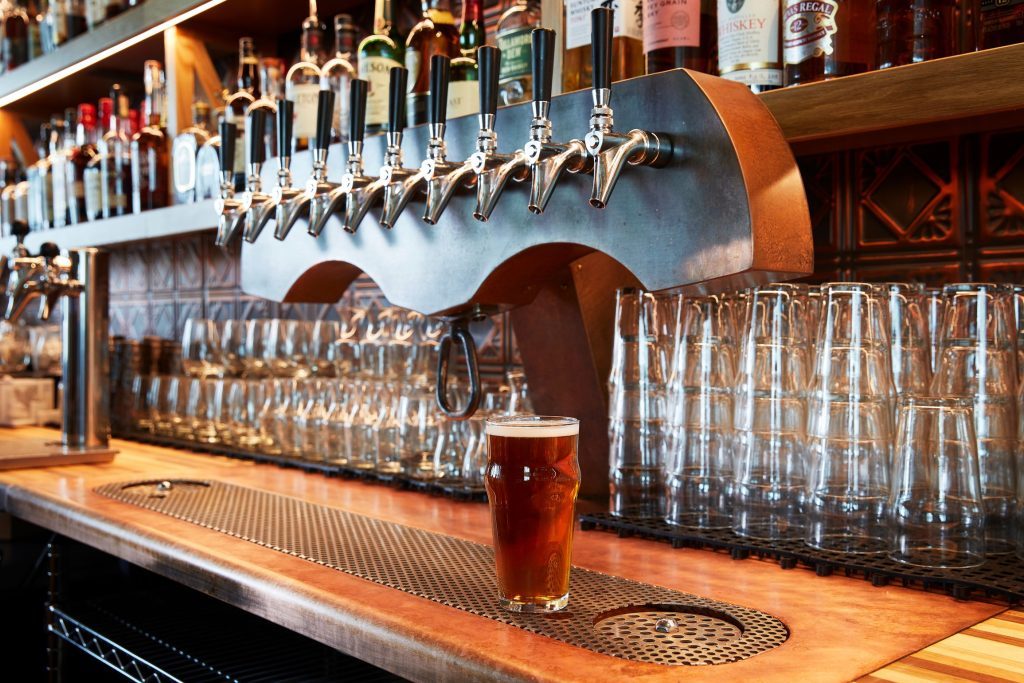 A beer draft dispensing system and a glass of beer