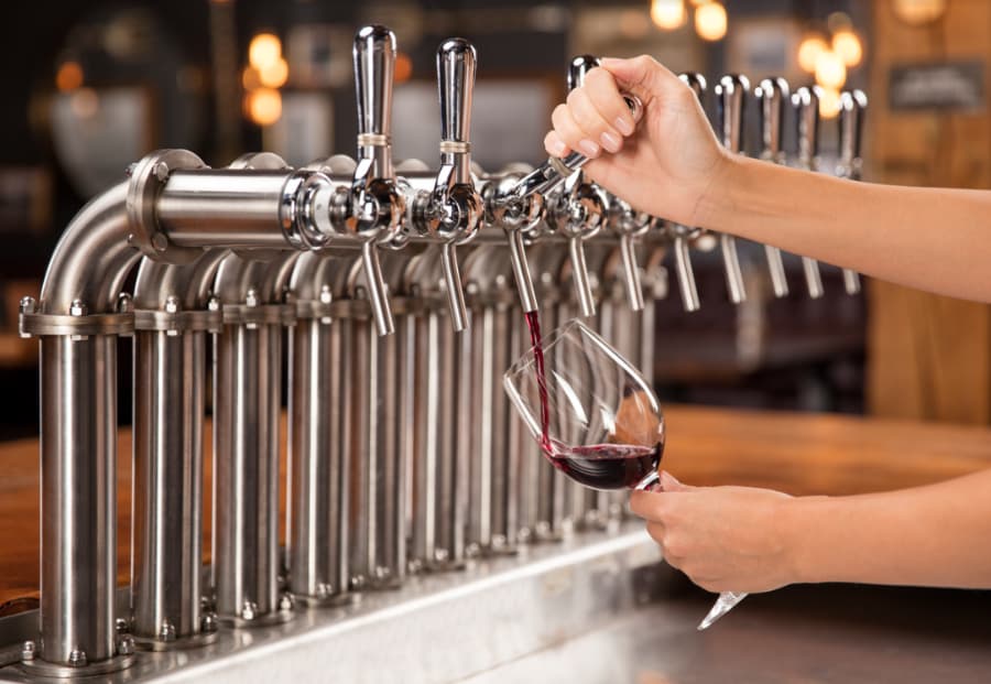 Draft wine being poured from a keg tap