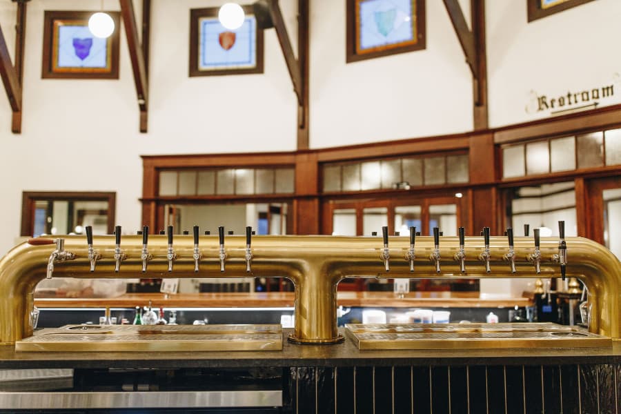 Bar with gold-themed beer tap distribution system