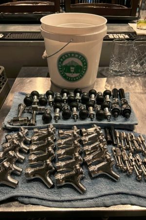 Faucets disassembled and laid out for hand cleaning